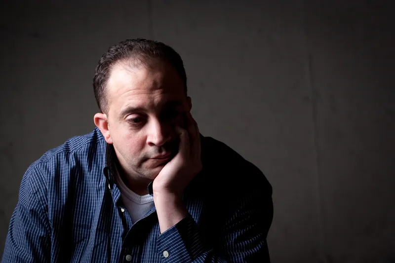  A man sitting alone in a dark room