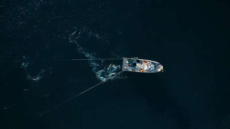 an aerial photo of a boat on a lake.