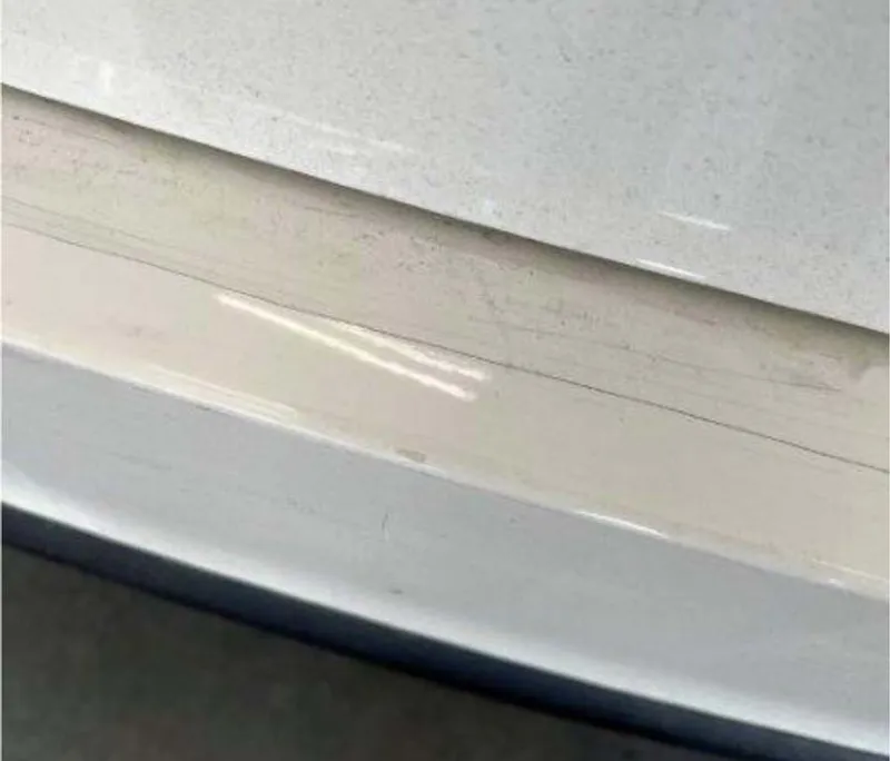 picture of a bumper with a hairline crack.